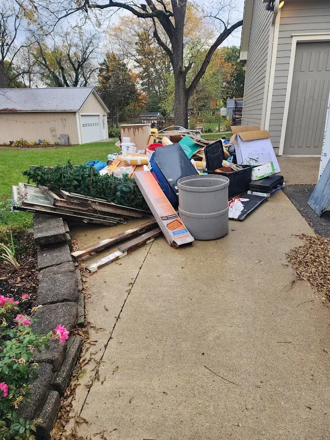 Dumpster being loaded with debris for 12 Yard Dumpster Rental in Home Gardens